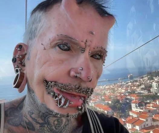 A man with 560 piercings, countless tattoos, and forehead implants – this is how he looked before