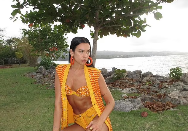 Dua Lipa shows off her fit physique as she strips down to a bright orange crochet bikini and matching cover up as she continues lavish Jamaica break